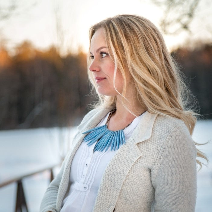 Light blue hand made design paper bead necklace made out of recycled paper in Uganda by principles of fair trade, ethical and sustainable fashion, empowering women of post war area, by Finnish / Scandinavian brand, Agulu Paper Beads. Eettinen vaaleansininen käsintehty design kaulakoru, joka on tehty kierrätyspaperista reilun kaupan periaattein työllistämällä kehitysmaan nasia.